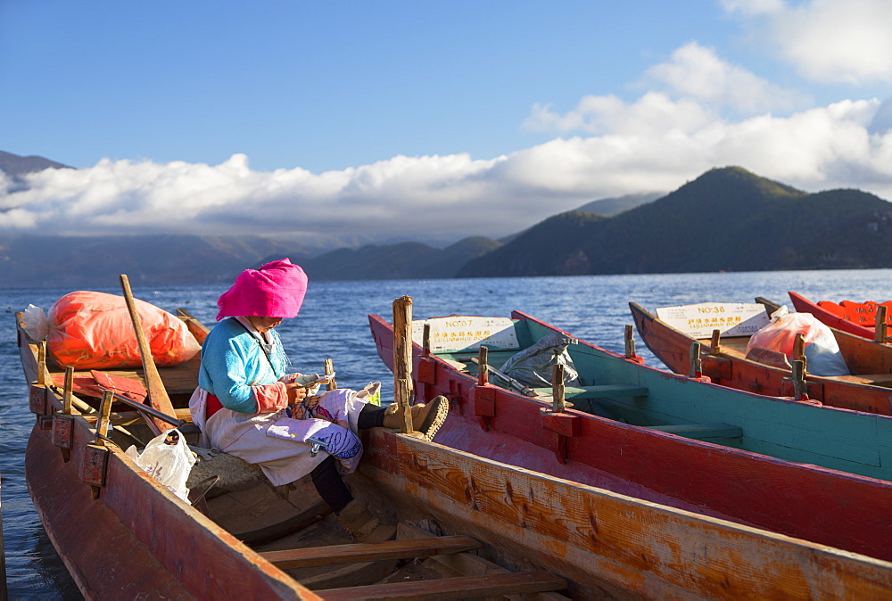 Mosu woman on boat, Luoshui, Lugu Lake, Yunnan, China, Asia