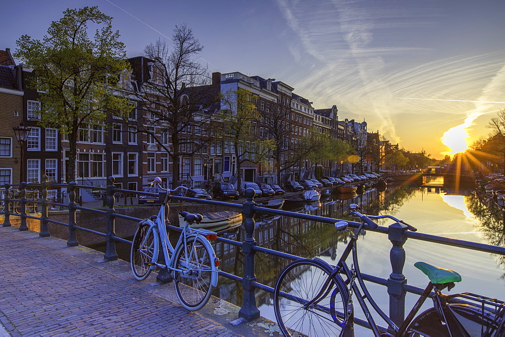 Bicycles on Keizersgracht canal at dawn, Amsterdam, Netherlands, Europe