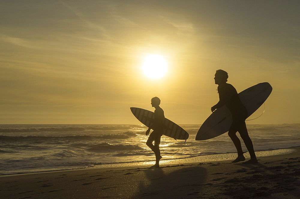 Surfers on Bloubergstrand at sunset, Cape Town, Western Cape, South Africa, Africa