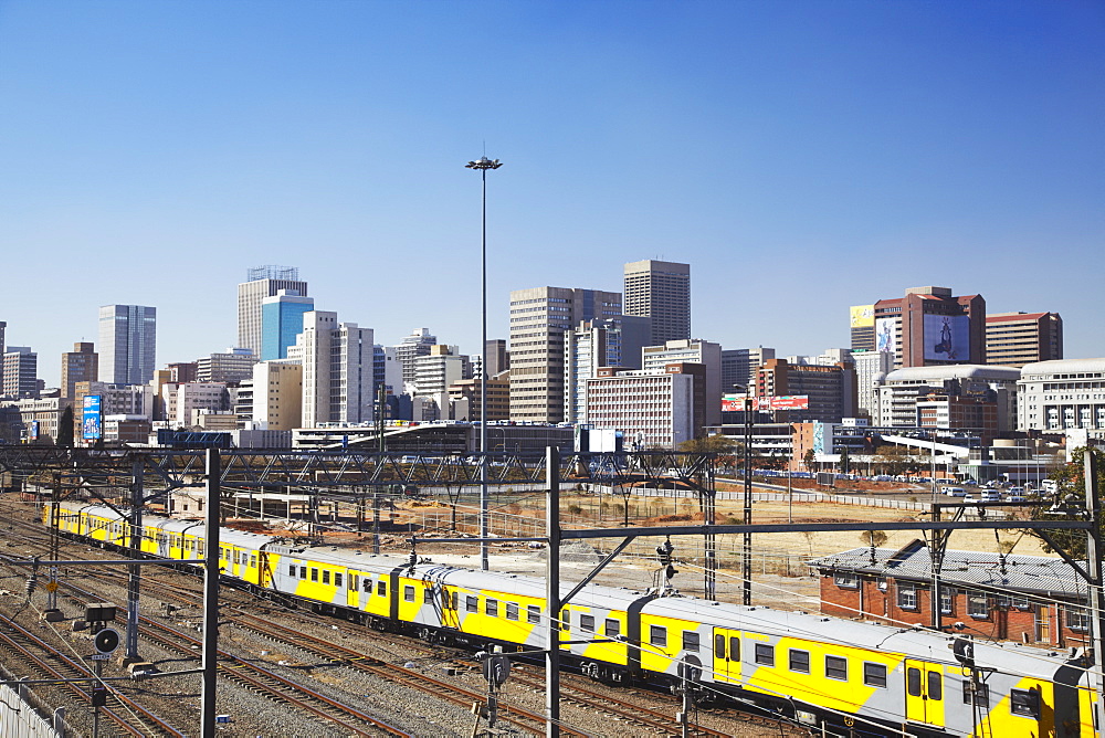 Train entering Park Station with city skyline in background, Johannesburg, Gauteng, South Africa, Africa