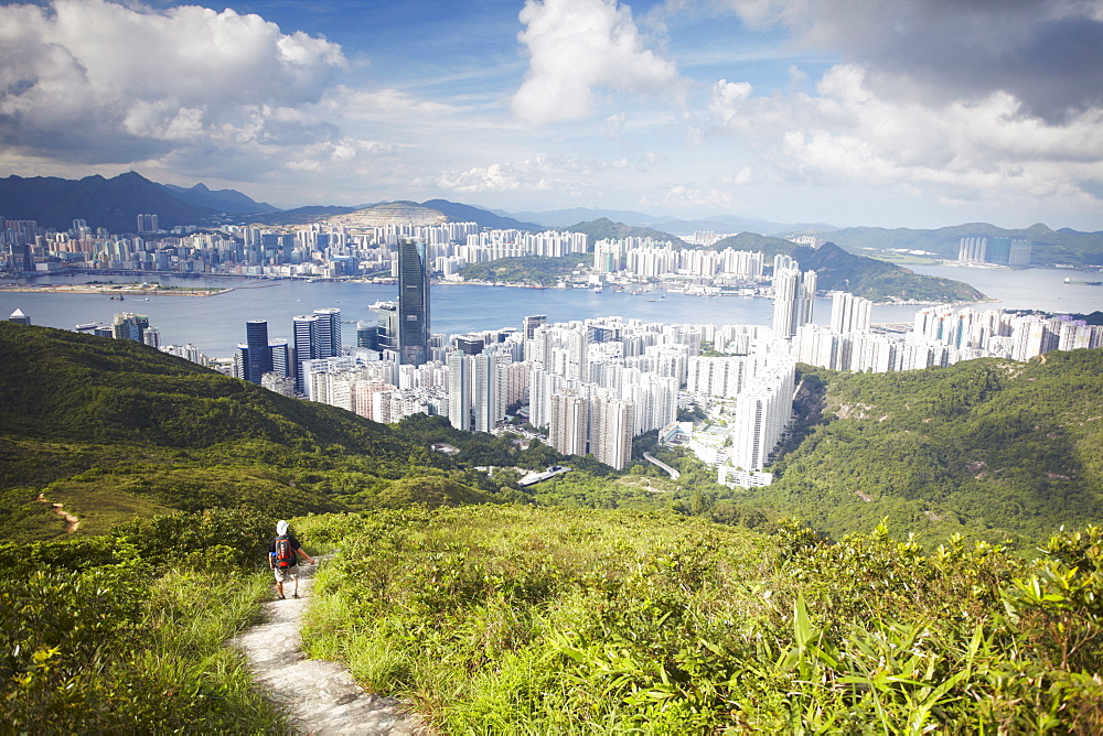 Man hiking on trail through hills behind Quarry Bay, Hong Kong, China, Asia