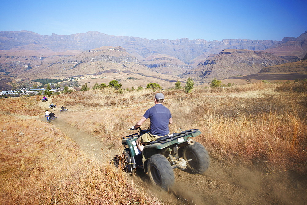 People quad biking in Cathedral Peak Nature Reserve, Ukhahlamba-Drakensberg Park, UNESCO World Heritage Site, KwaZulu-Natal, South Africa, Africa