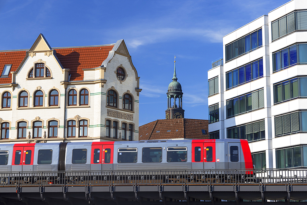 U-Bahn train passing along raised track, Hamburg, Germany