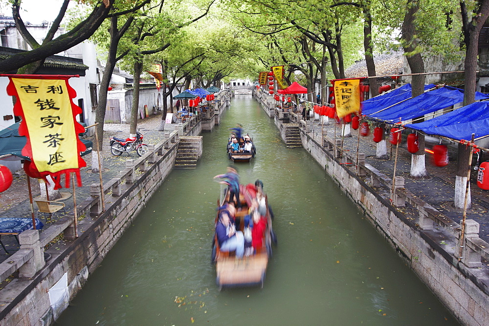 Boats taking tourists along canal, Tongli, Jiangsu, China, Asia