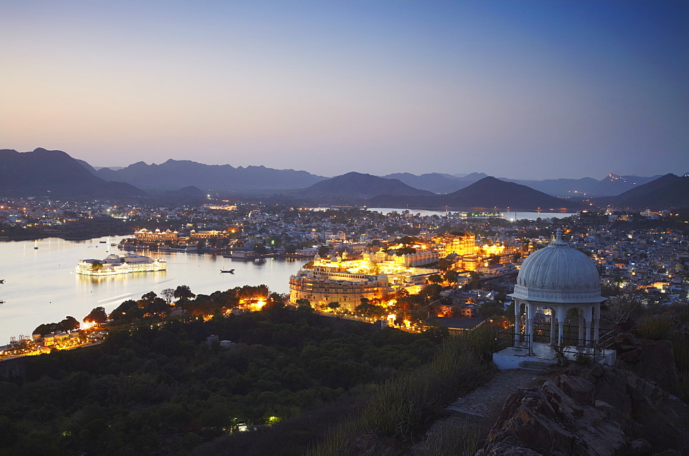 View of City Palace and Lake Palace Hotel at sunset, Udaipur, Rajasthan, India, Asia