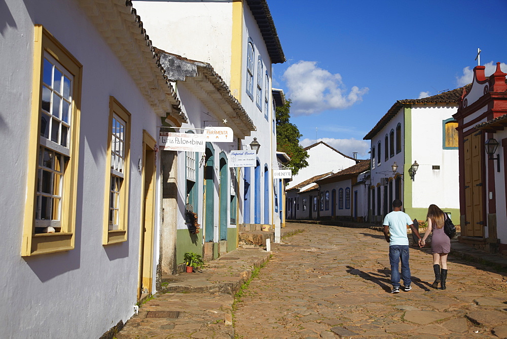 Couple walking along street, Tiradentes, Minas Gerais, Brazil, South America 