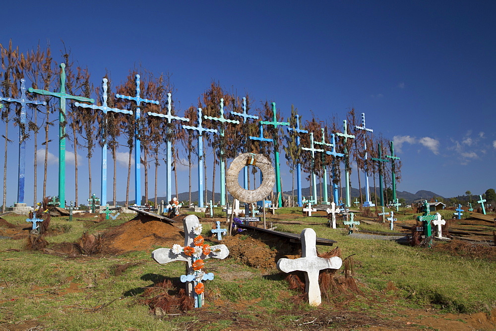 A series of tall crosses at the crest of the graveyard, boards represent doors to and from the grave, village of El Romerillo, Chiapas, Mexico, North America 