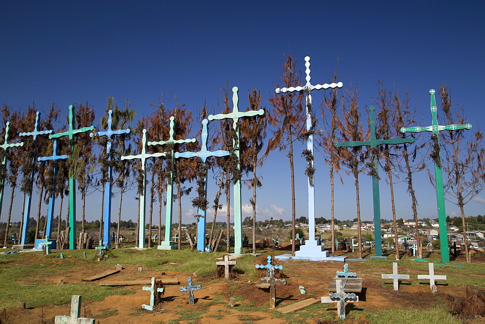 A series of tall crosses at the crest of the graveyard, boards represent doors to and from the grave, village of El Romerillo, Chiapas, Mexico, North America 