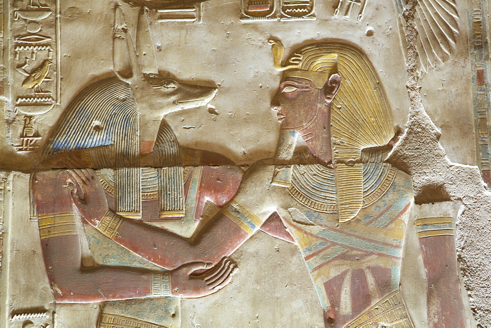 Bas-relief of the God Anubis on left, with the Pharaoh Seti I, Temple of Seti I, Abydos, Egypt, North Africa, Africa