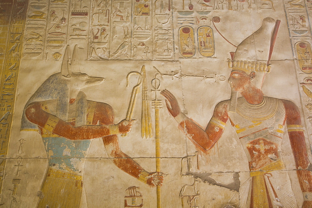 Bas-relief of the God Anubis on left and Ramses II on right, Temple of Seti I, Abydos, Egypt, North Africa, Africa