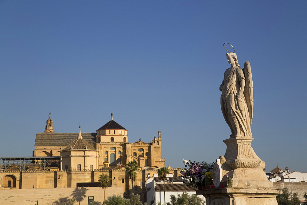 Statue of Raphael the Archangel with the Great Mosque (Mesquita) and Cathedral of Cordoba in the background, Cordoba, Andalucia, Spain, Europe