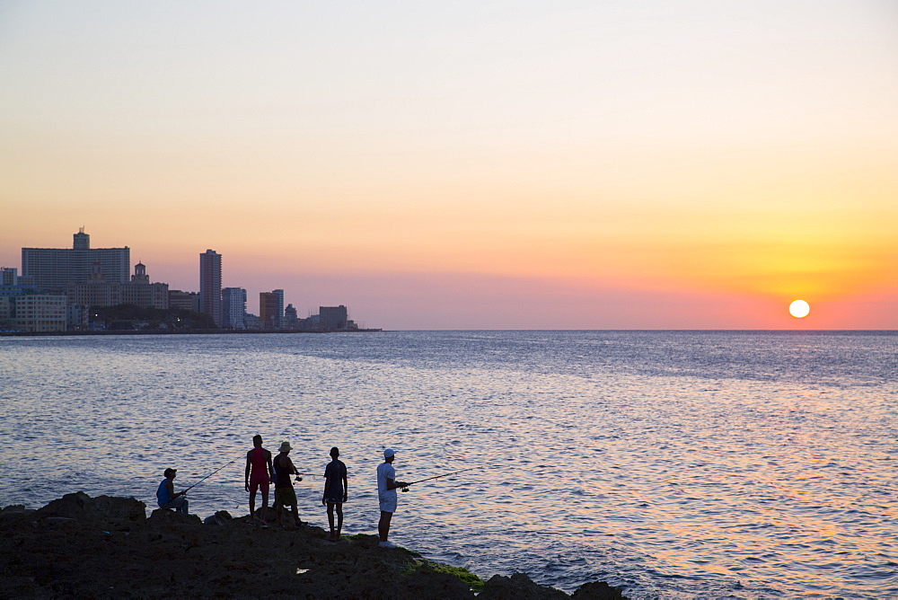 Locals fishing from the Malecon in the evening, Centro Habana, Havana, Cuba, West Indies, Central America