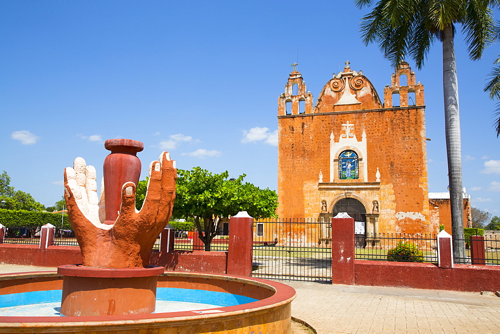 Hands Fountain in foreground, Church of San Antonio de Padua in background, Ticul, Yucatan, Mexico, North America