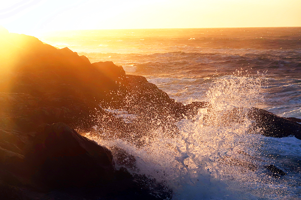 The Atlantic Ocean break on rocks at Boat Cove, West Penwith, Cornwall, England