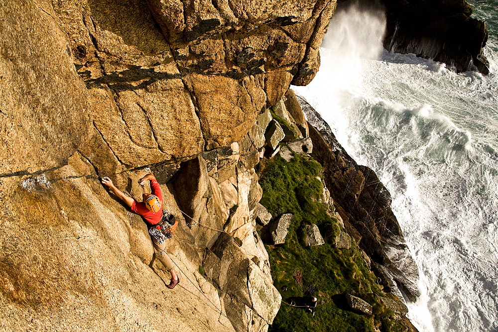 A climber on the classic extreme route Raven Wall on the cliffs at Bosigran, near St. Just, West Penwith, Cornwall, England, United Kingdom, Europe