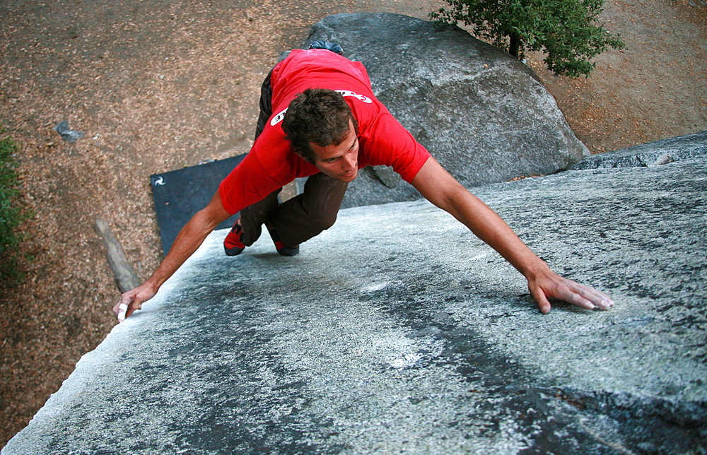 A climber bouldering on the large granite boulders near Camp 4, the National Park Service campground underneath El Capitan, Yosemite Valley, California, United States of America, North America