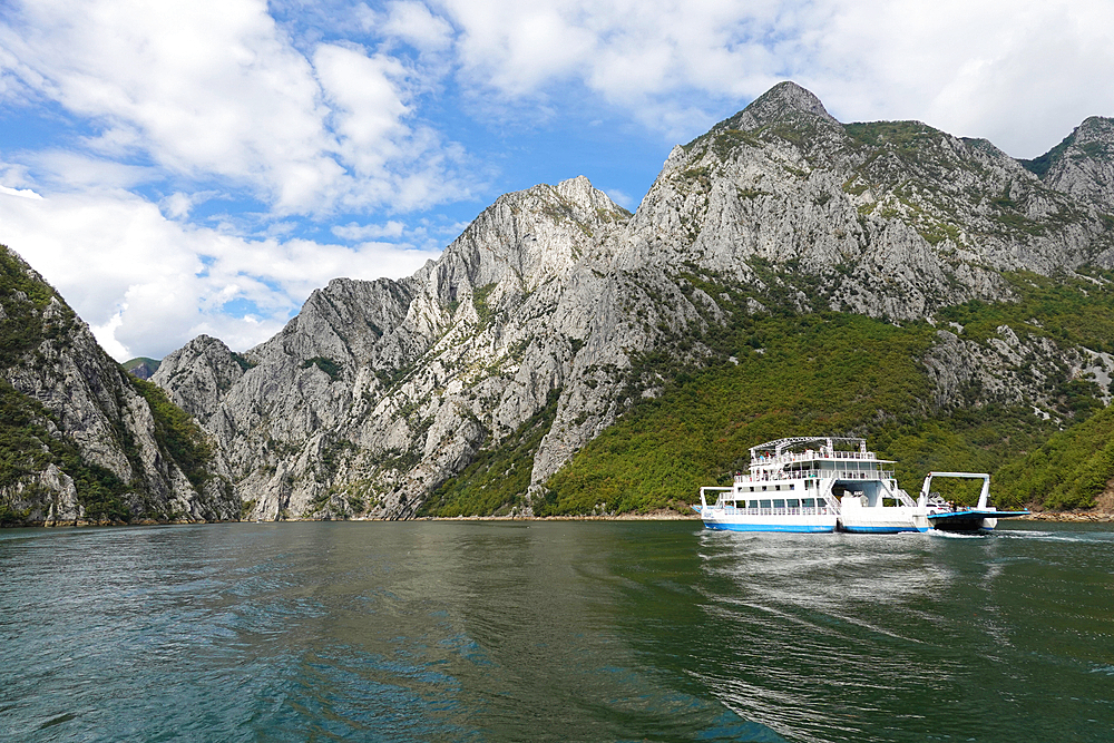 Lake Koman, a reservoir on the Drin River in northern Albania, surrounded by dense forested hills, vertical slopes, deep gorges, and a narrow Valley, Albania, Europe