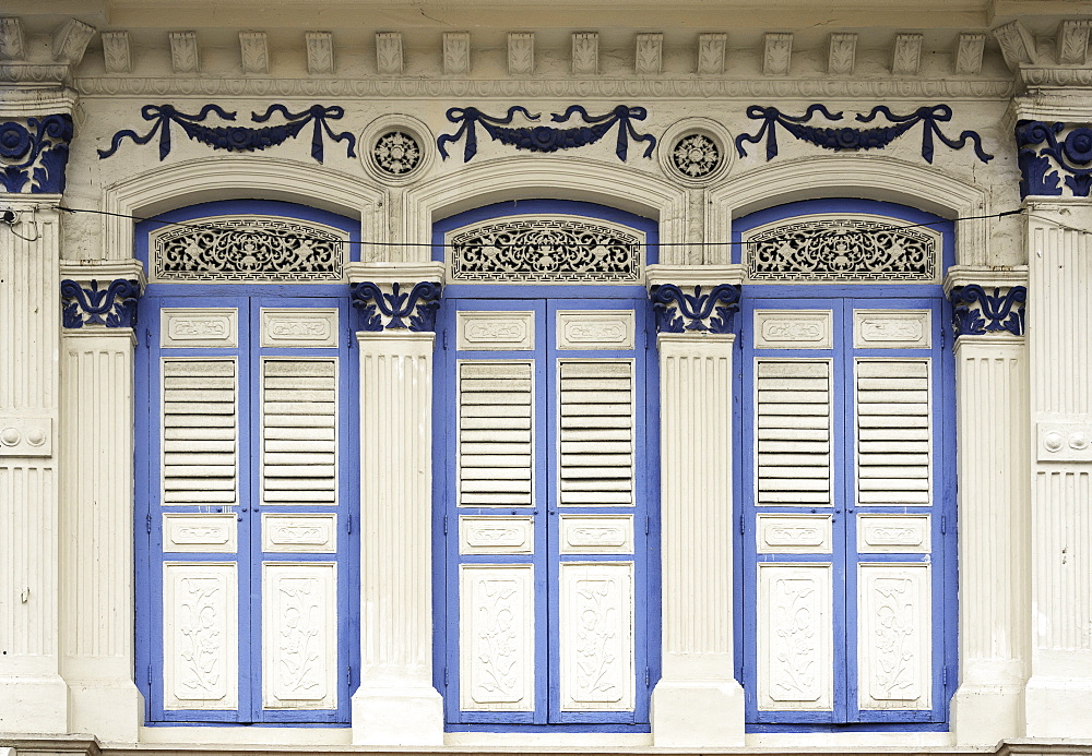 Close-up of traditional old houses with shuttered windows and decorative mouldings in Little India, Singapore, Southeast Asia, Asia