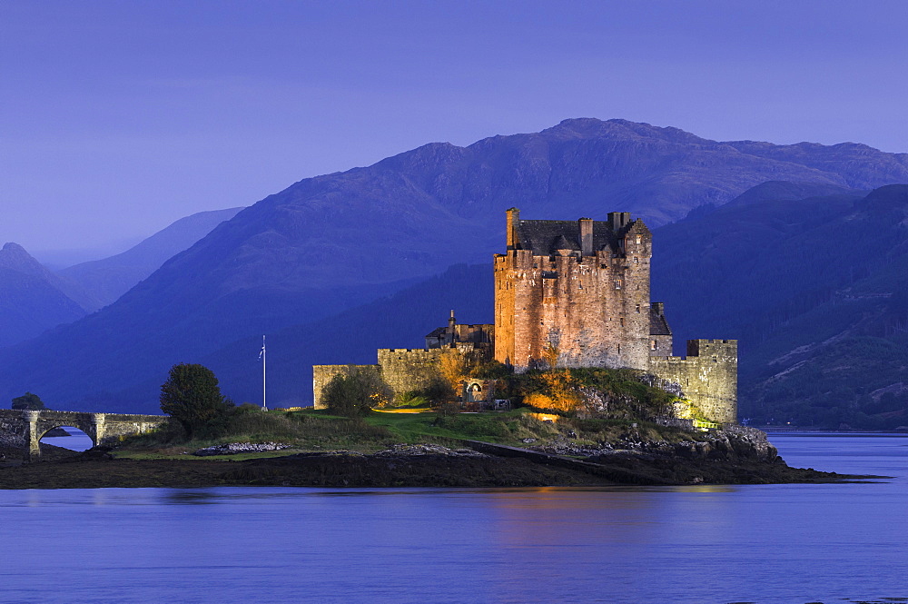 Eilean Donan Castle floodlit at night on Loch Duich, Scotland, United Kingdom, Europe