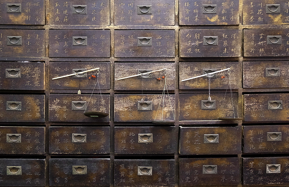 Old wooden drawers and scales in a Chinese pharmacy in  Melaka (Malacca), Malaysia, Southeast Asia, Asia