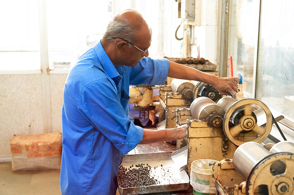 Man manufacturing Ayurvedic pills in the Ayurveda Rasshala herbal medicine workshop cum factory