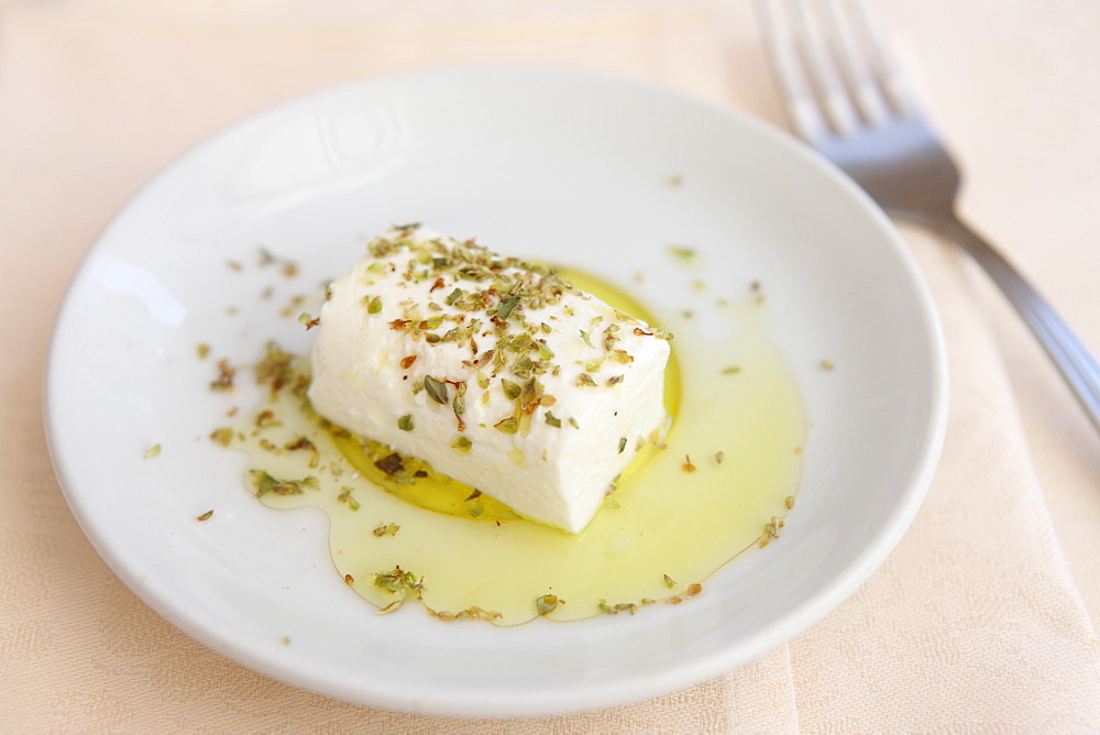 Italian cheese dish of caprino with olive oil and oregano, Italy, Europe