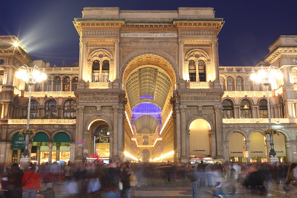 Galleria Vittorio Emanuele entrance illuminated at dusk, Milan, Lombardy, Italy, Europe