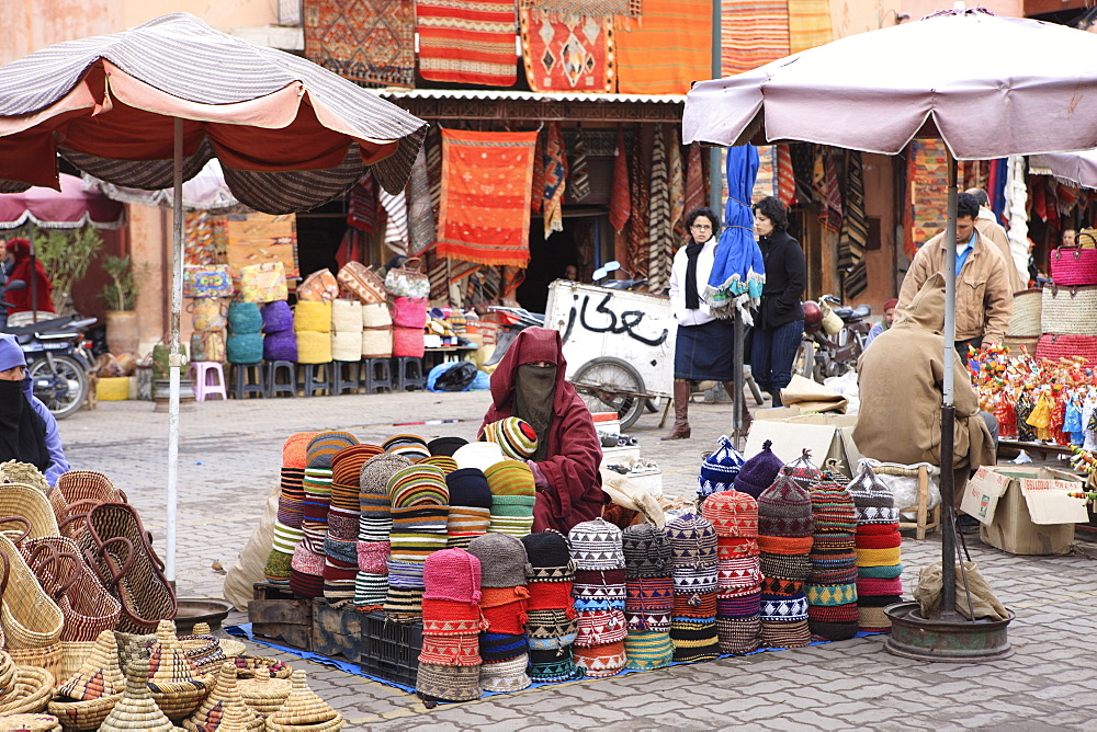 Market trader on hat stall, Marrakech, Morocco, North Africa, Africa