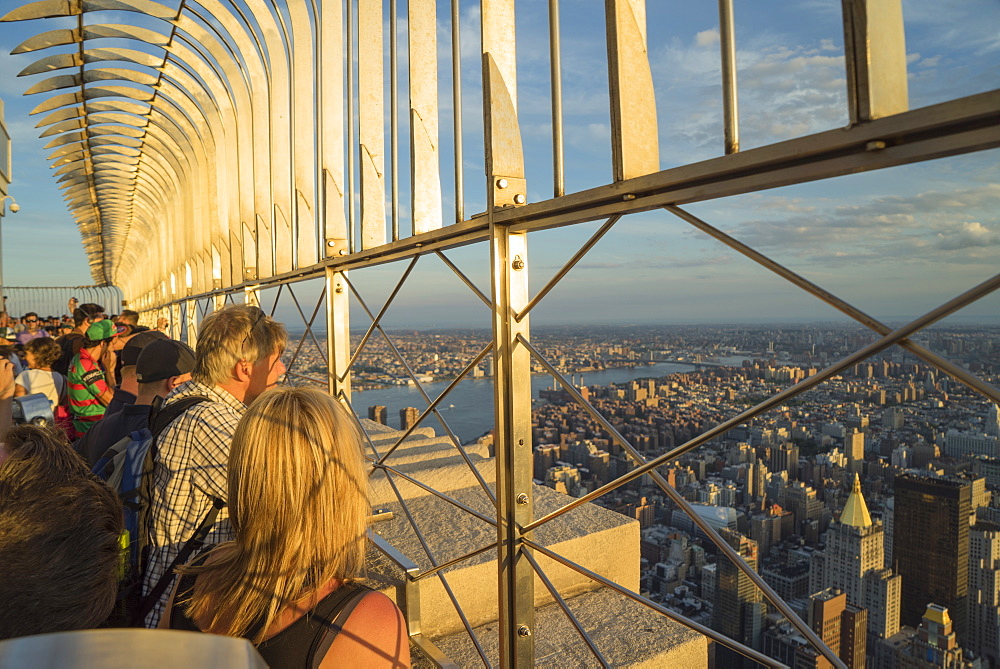 Tourists at the Empire State Building viewing platform enjoying the view, Manhattan, New York City, New York, United States of America, North America