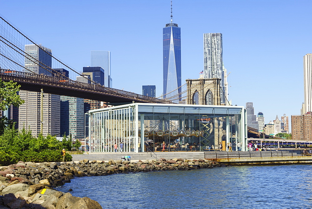 Jane's Carousel in Brooklyn Bridge Park with Brooklyn Bridge and Lower Manhattan skyscrapers including One World Trade Center beyond, New York City, New York, United States of America, North America