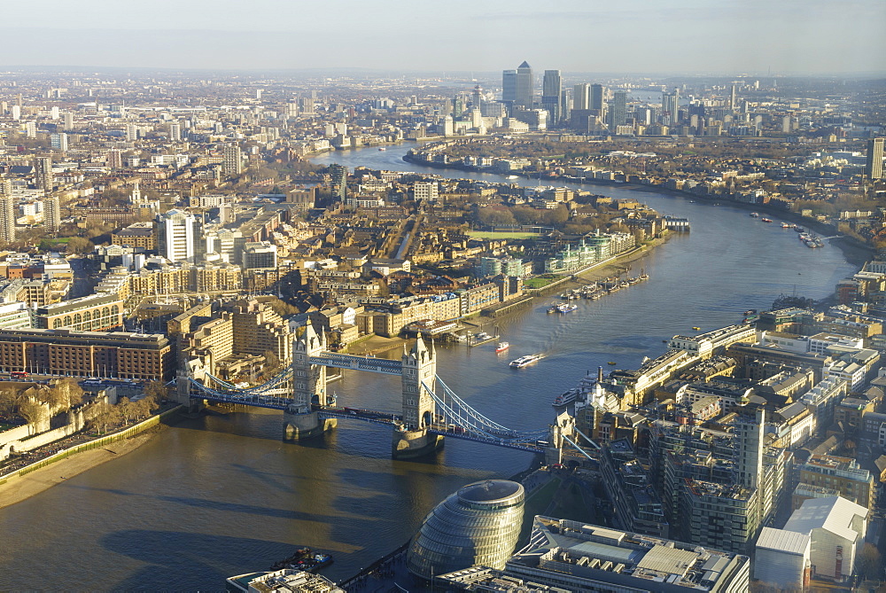 Elevated view of the River Thames looking East towards Canary Wharf with Tower Bridge in the foreground, London, England, United Kingdom, Europe