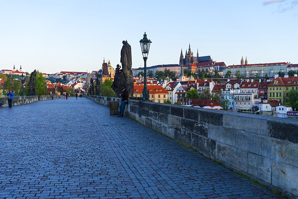 Early morning on Charles Bridge looking towards Prague Castle and Hradcany, UNESCO World Heritage Site, Prague, Czech Republic, Europe