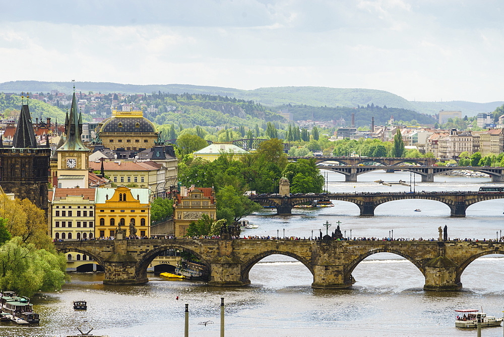 Prague cityscape looking down the Vltava River at its bridges connecting the Old Town to Mala Strana, Prague Castle and Hradcany, Prague, Czech Republic, Europe