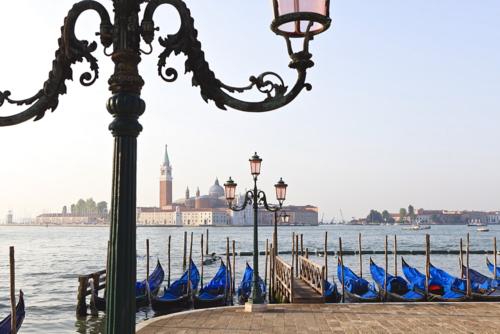 Gondolas moored on the Lagoon, San Giorgio Maggiore beyond, Riva degli Schiavoni, Venice, UNESCO World Heritage Site, Veneto, Italy, Europe