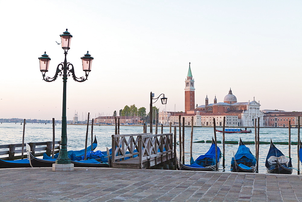 Gondolas moored on the Lagoon, San Giorgio Maggiore beyond, Riva degli Schiavoni, Venice, UNESCO World Heritage Site, Veneto, Italy, Europe