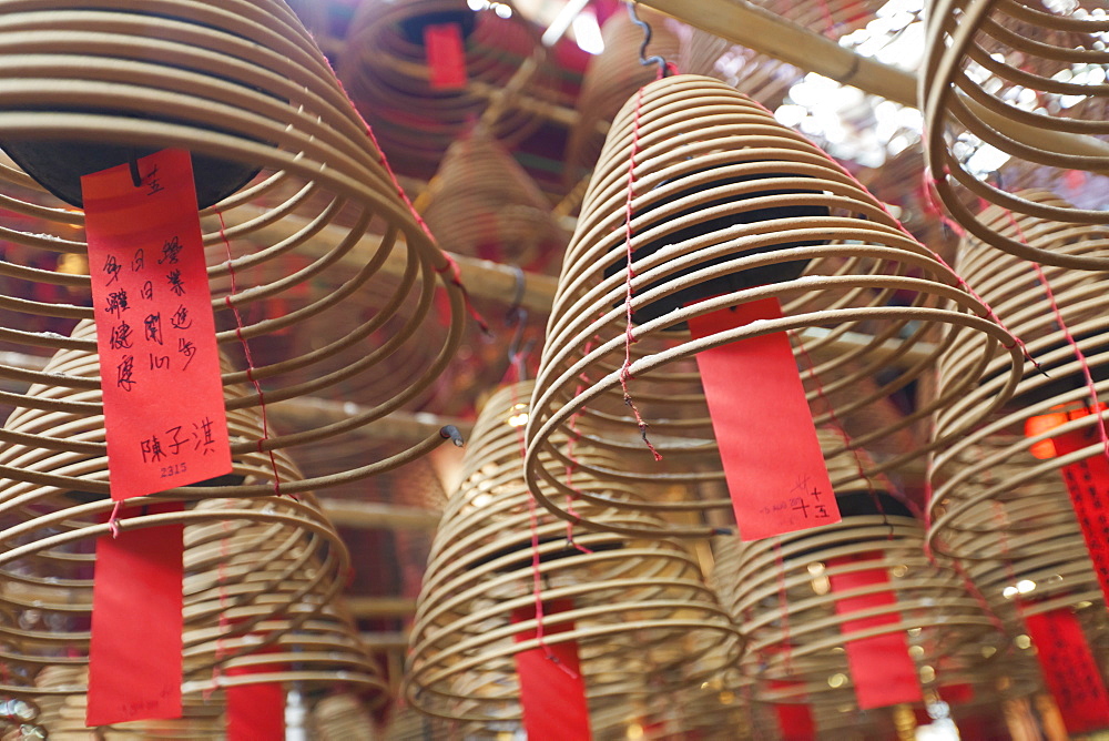 Incense coils hang from the roof of the Man Mo Temple, built in 1847, Sheung Wan, Hong Kong, China, Asia