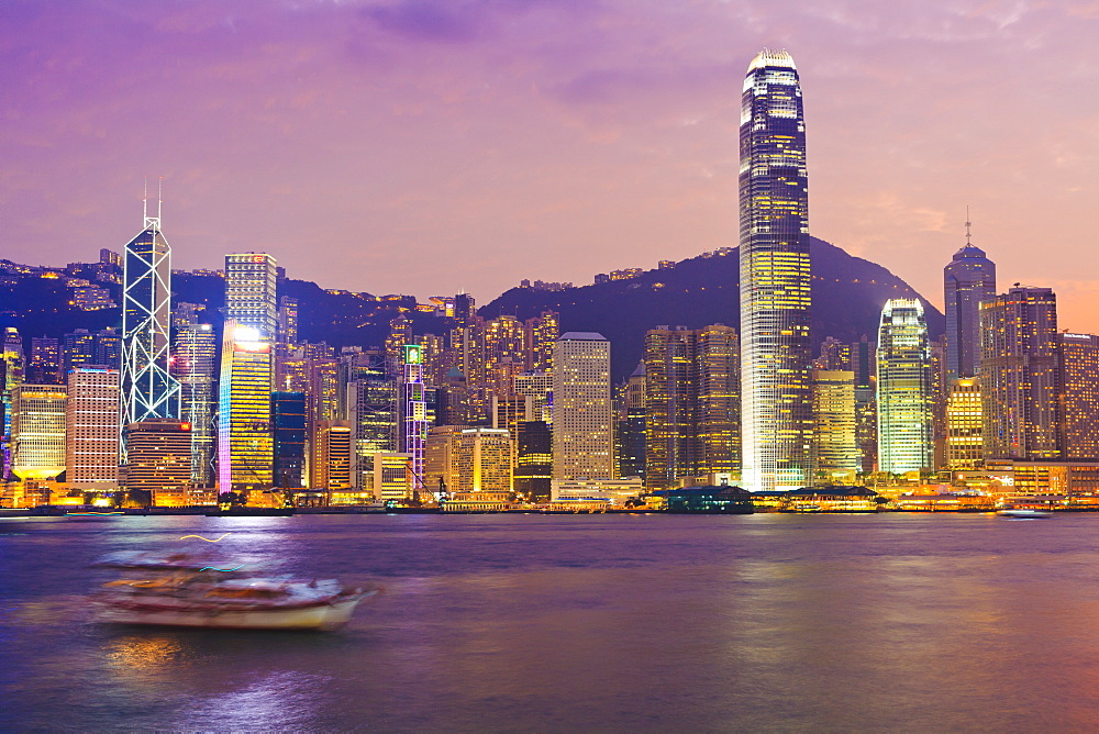 The skyscrapers of Hong Kong Island illuminated at sunset across Victoria Harbour, Two International Finance Centre tower (2IFC), on the right, Hong Kong, China, Asia