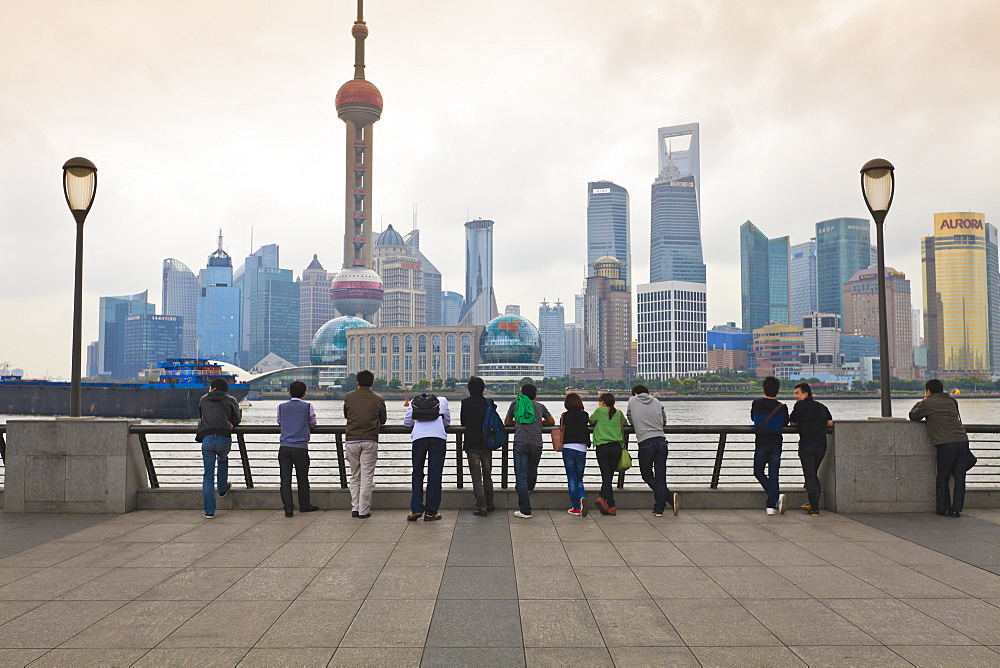 People viewing the Pudong skyline and the Oriental Pearl Tower from the Bund, Shanghai, China, Asia