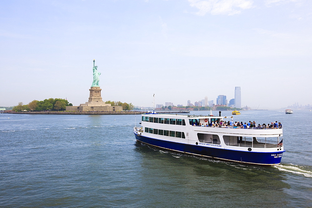 The Statue of Liberty and ferry, Liberty Island, New York City, New York, United States of America, North America