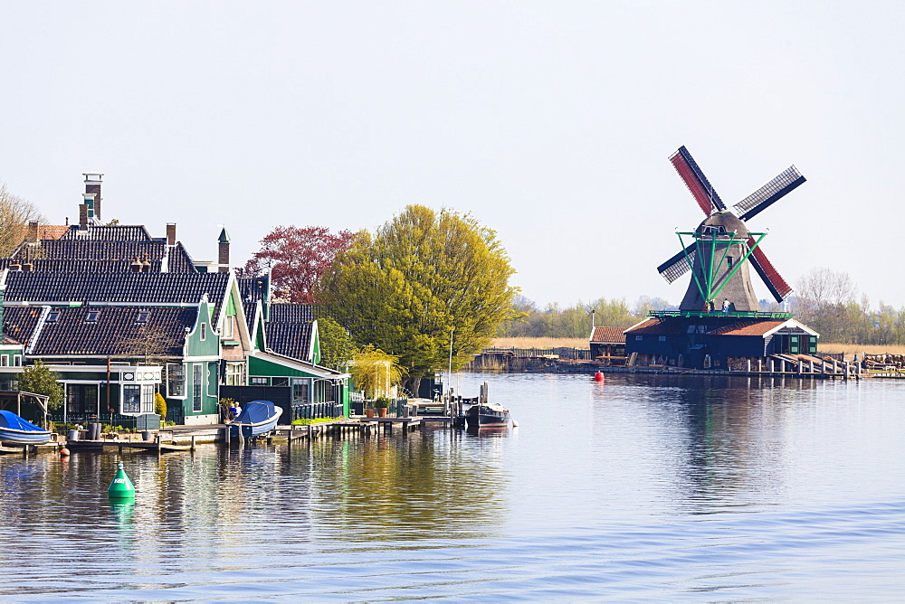 Preserved historic windmills and houses in Zaanse Schans, a village on the banks of the River Zaan, near Amsterdam, a tourist attraction and working museum, Zaandam, North Holland, Netherlands, Europe 