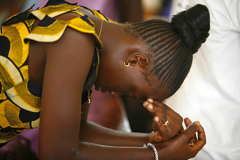 Woman praying at mass in Popenguine, Popenguine, Thies, Senegal, West Africa, Africa