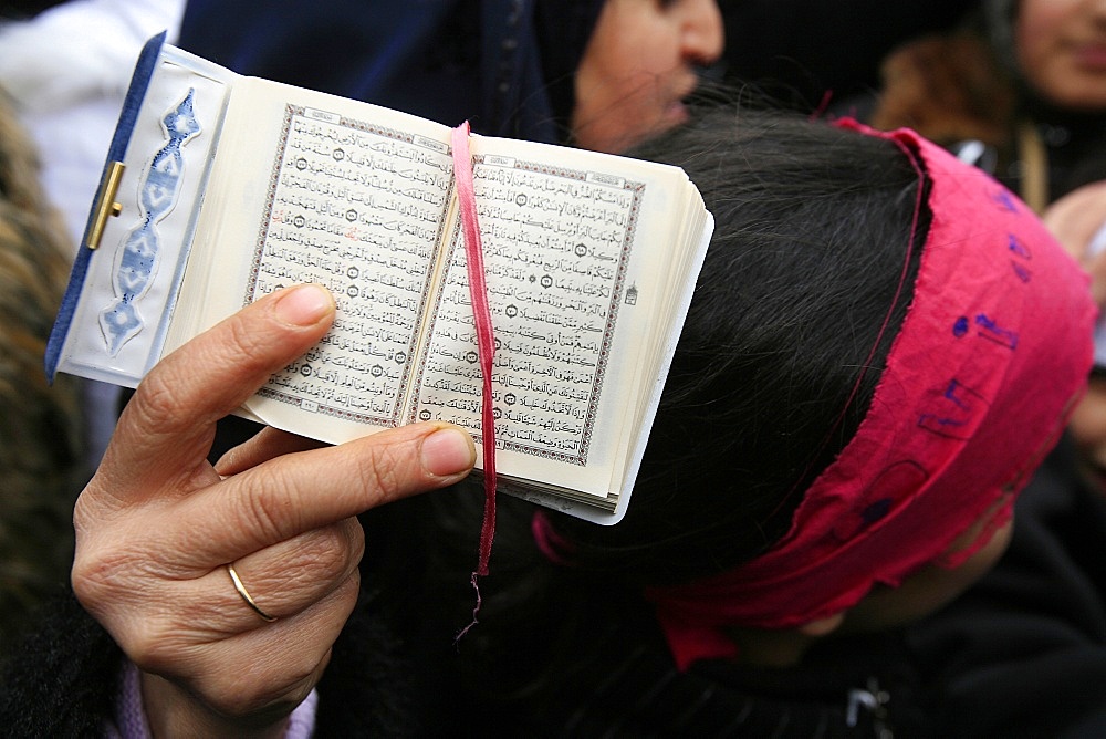 Koran being held during a Muslim demonstration, Paris, France, Europe