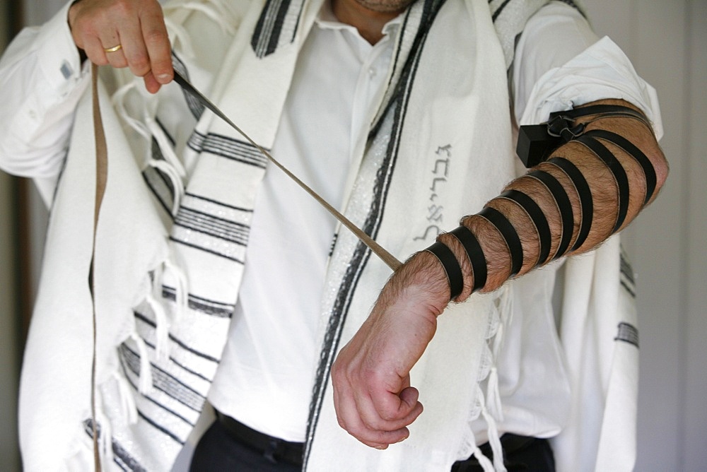 Rabbi putting on phylacteries, Paris, France, Europe