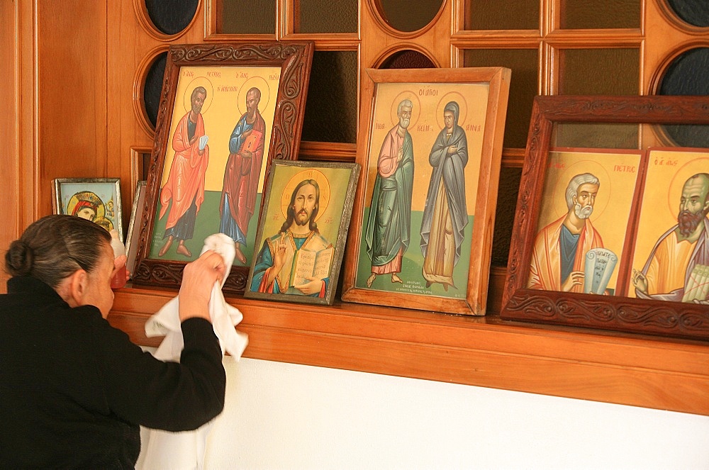 Greek Orthodox woman cleaning icons, Thessaloniki, Macedonia, Greece, Europe