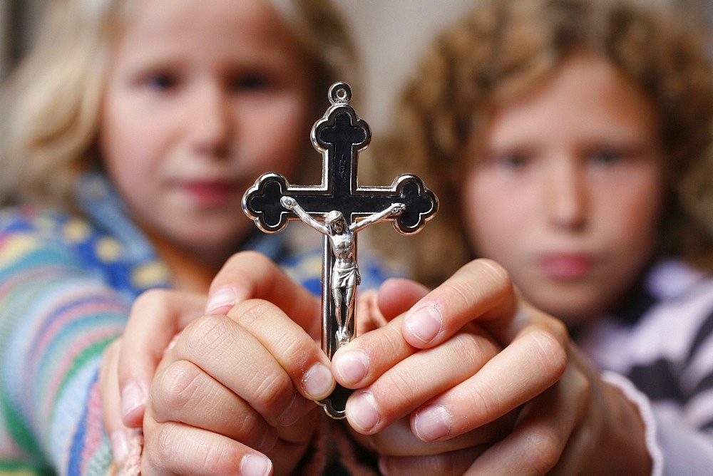 Children holding a crucifix, Haute Savoie, France, Europe