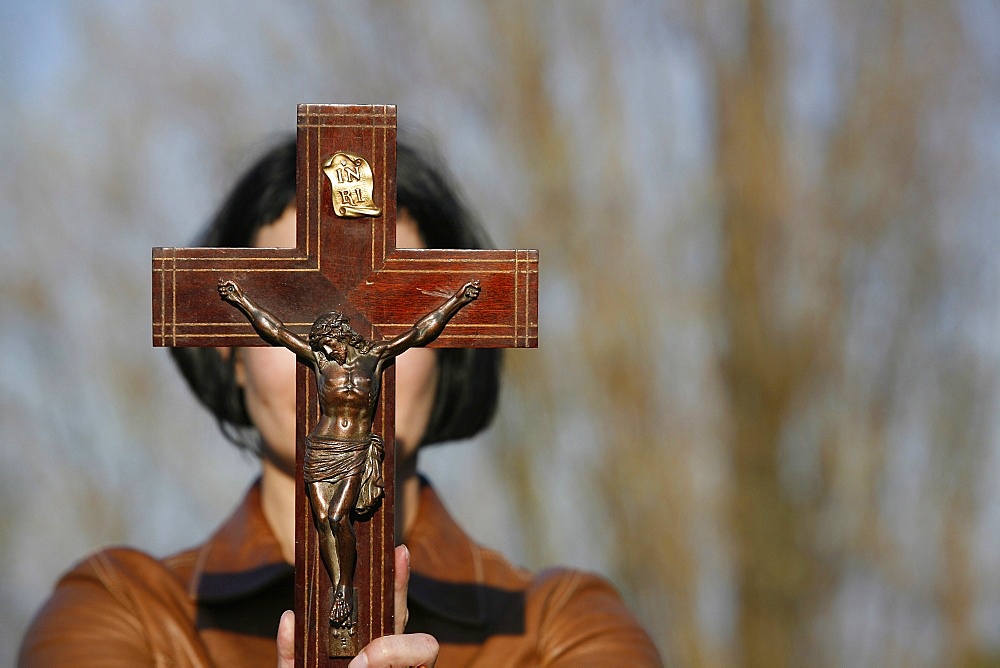 Woman holding forth a crucifix, Isere, France, Europe