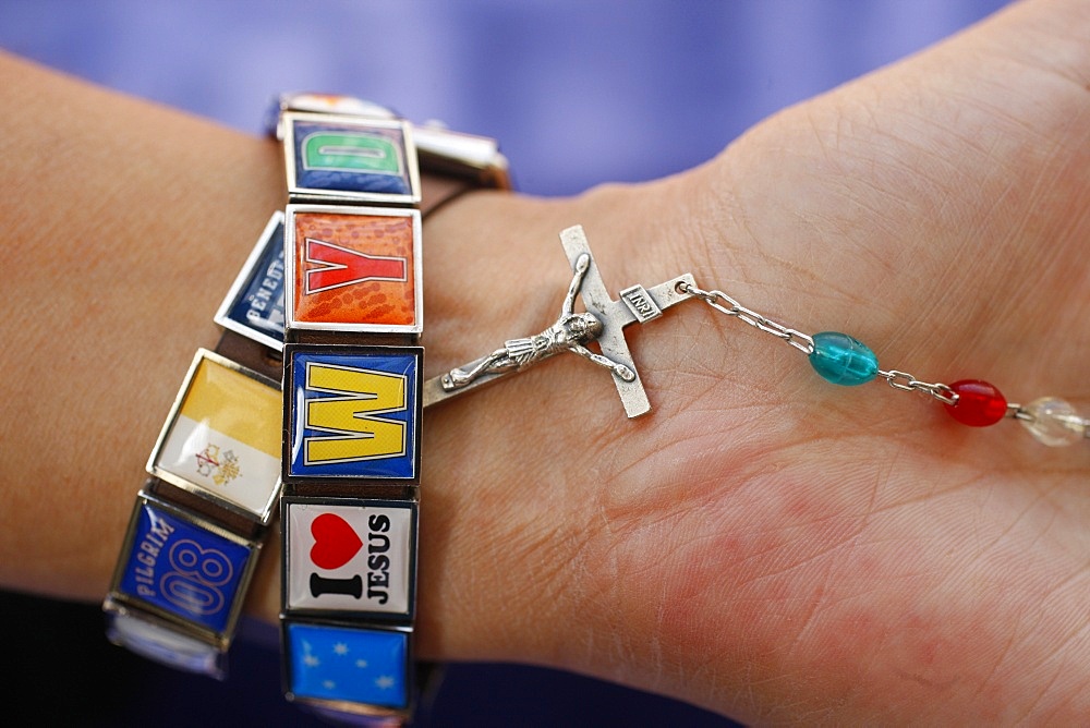 Woman with World Youth Day bracelet holding rosary, Sydney, New South Wales, Australia, Pacific