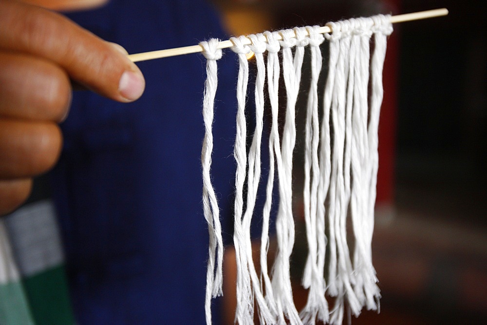 Lao Buddhist ceremony with cotton bracelets, Paris, France, Europe