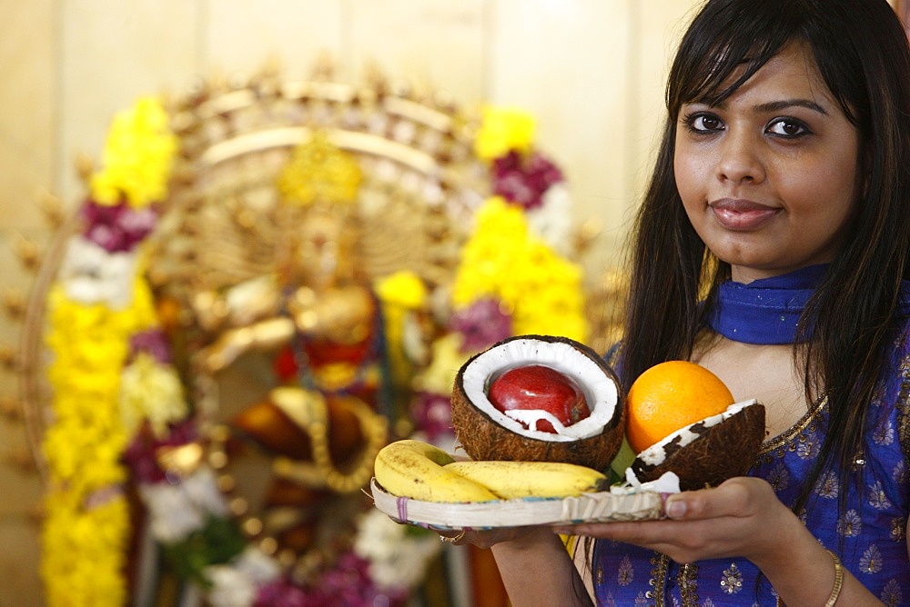 Woman with offerings in Highgate Hill Hindu temple, London, England, United Kingdom, Europe