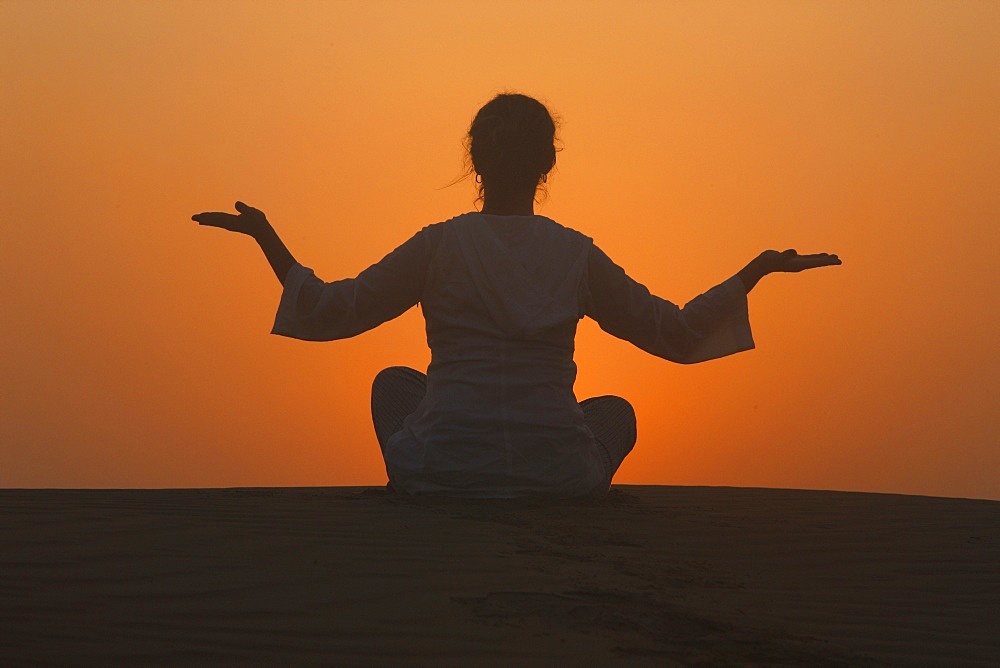 Sunset meditation in the desert, Abu Dhabi, United Arab Emirates, Middle East